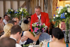 Kent wedding toastmaster delivering flowers to a wedding guest