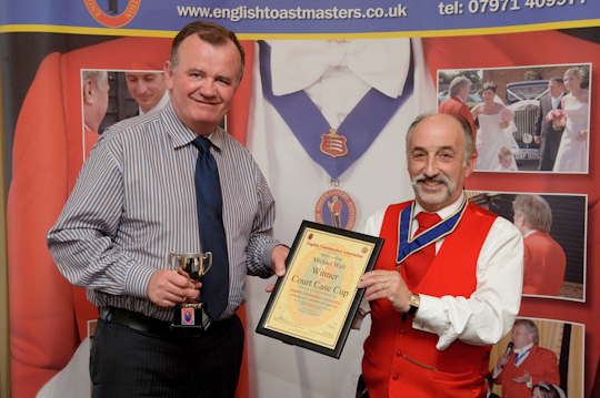 Our first award for outstanding services to our Association goes to Michael Wall. Here Michael is shown with Howard Marco receiving the Court Case Cup