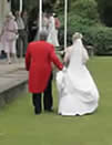 wedding toastmaster Richard Palmer assisting the bride with her wedding dress