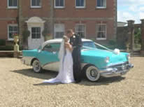 Bride and Groom with their wedding car