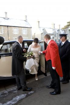 Bride arriving in the wedding car and greeted by the Dorset wedding toastmaster