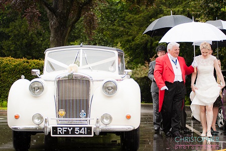 Kentish Toastmaster Tony Pule with the bride and an umbrella