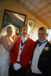 English toastmaster Eric Jones with a bride and bridegroom